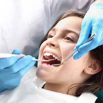 Child in the dental chair dental treatment during surgery.